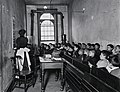 "A Class in the Condemned Essex Market School, With the Gas Burning by Day" (5389944638).jpg